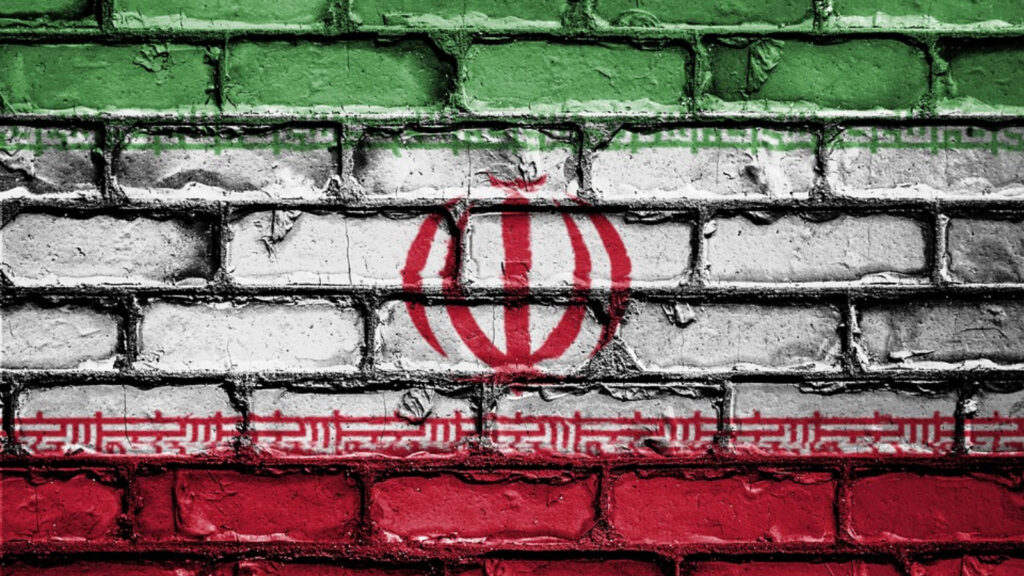 Iranian Flag painted on a wall. 3 bars in green, white and red, mullah symbol in the middle and a confession of faith above the red bar
