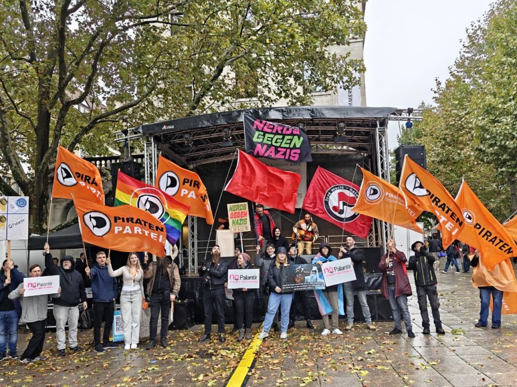 Aufstellung vor der Bühne in Stuttgart mit Flaggen gegen Palantir